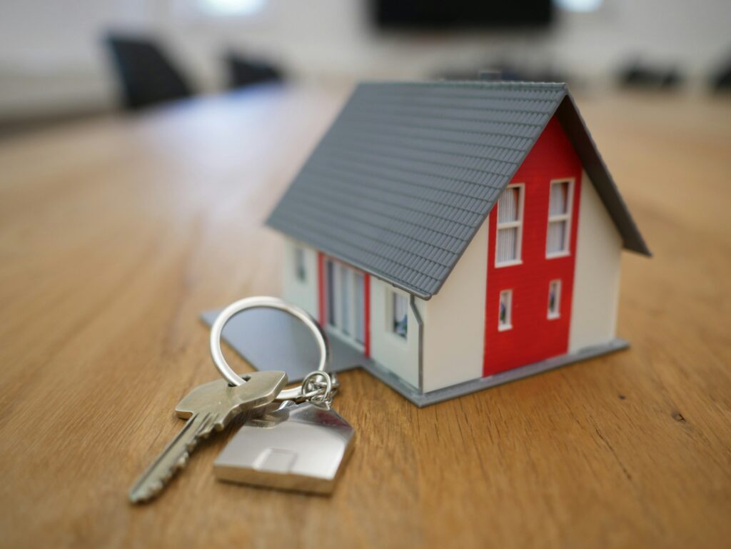 A model house and keys on a table